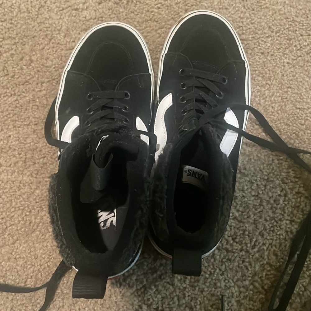 Black and white high top Vans